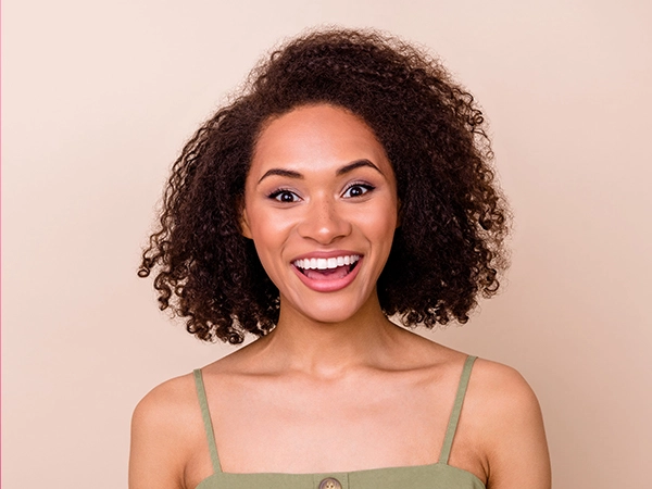 Young woman of colour with bright white smile